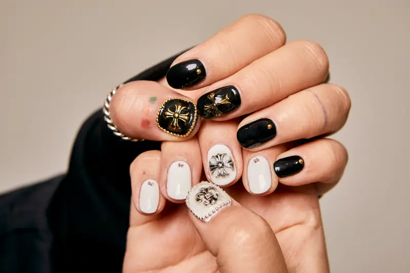 Black and white nails with hand-painted motifs
