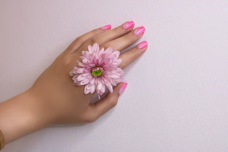 Soft pink manicure with a pink flower