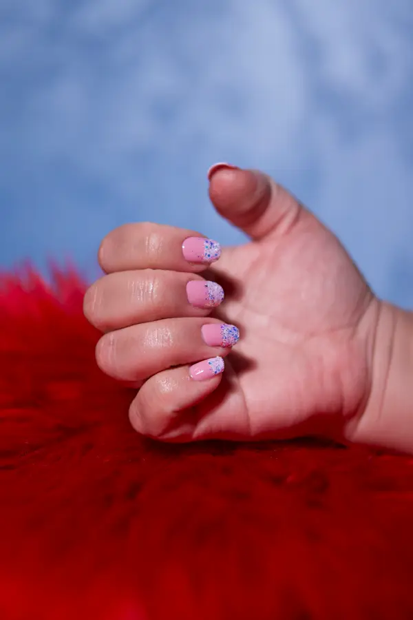 Pink gel nails with glitter tips