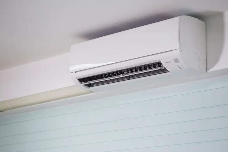 A white wall-mounted aircon unit in a bright room